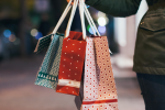 Shopper holding holiday gift bags